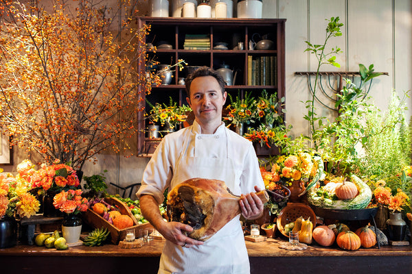 Paul Wetzel holds a prosciutto at Gramercy Tavern