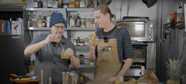 Chef Neil Kleinberg and Matt Botkin making a cocktail