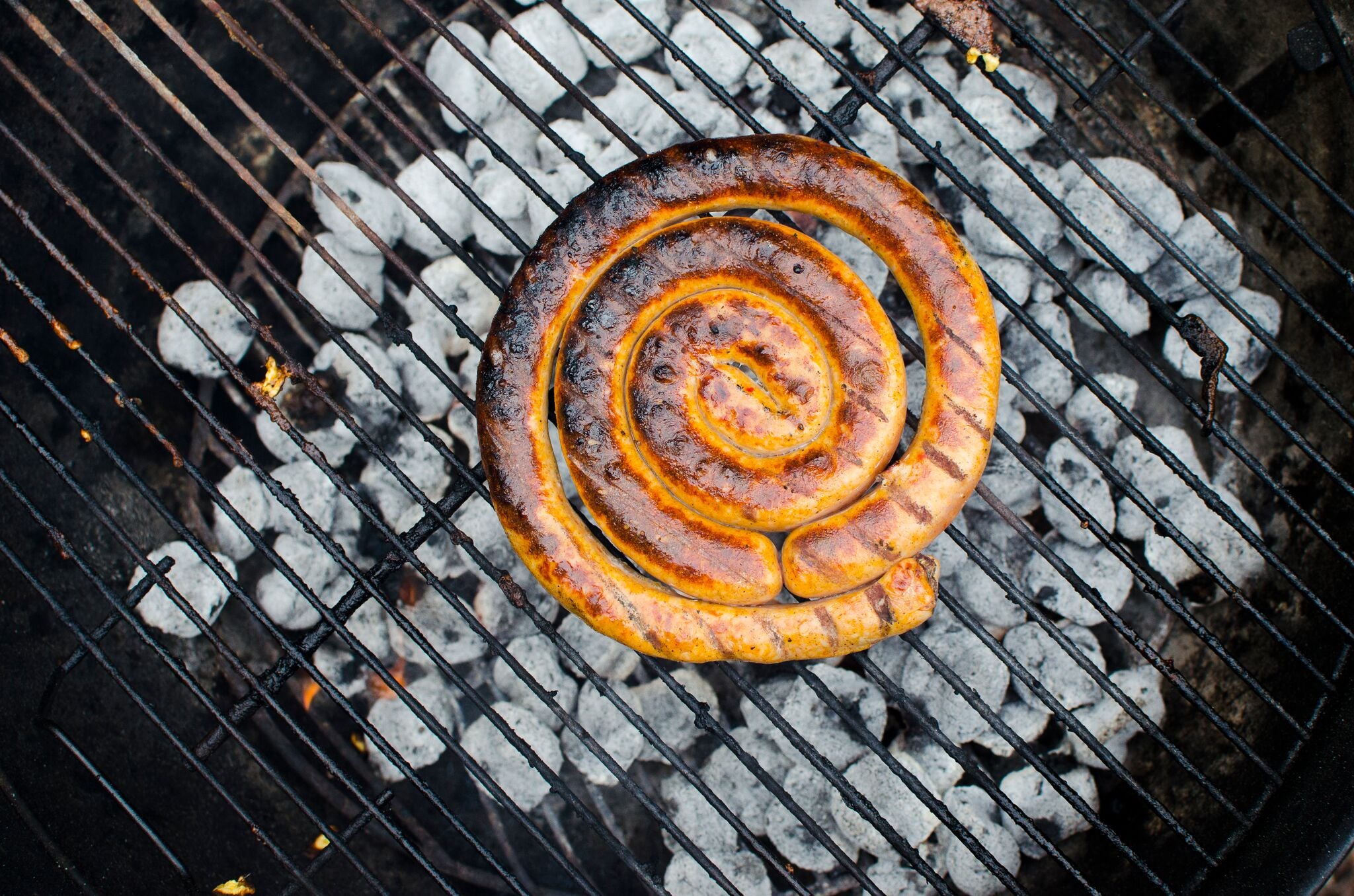 Heritage Pork Sausage Wheel on the grill